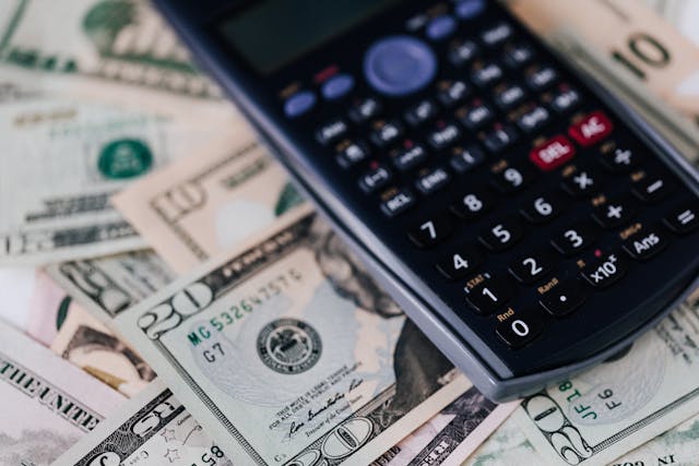 a calculator on top of cash