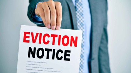 person holding up an eviction notice sign