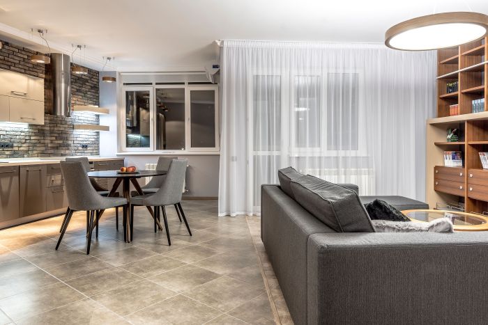 Elegant open-concept living room and kitchen with contemporary decor, emphasizing comfort and style