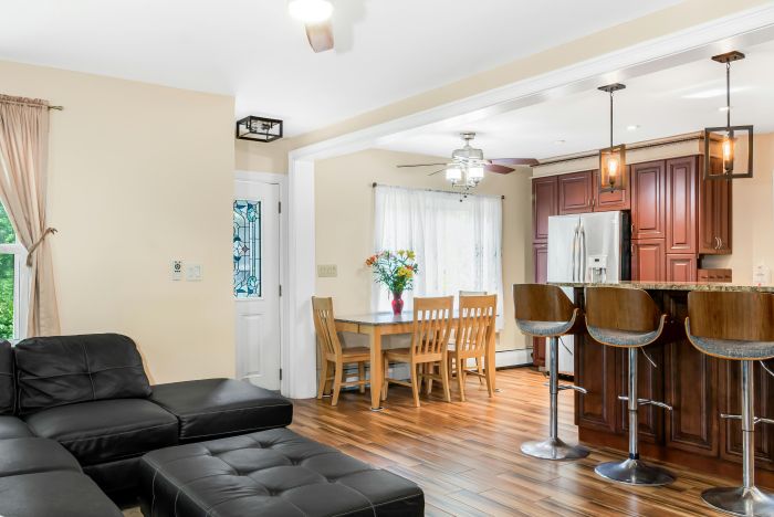 Elegant open-concept living room and kitchen with contemporary decor, emphasizing comfort and style